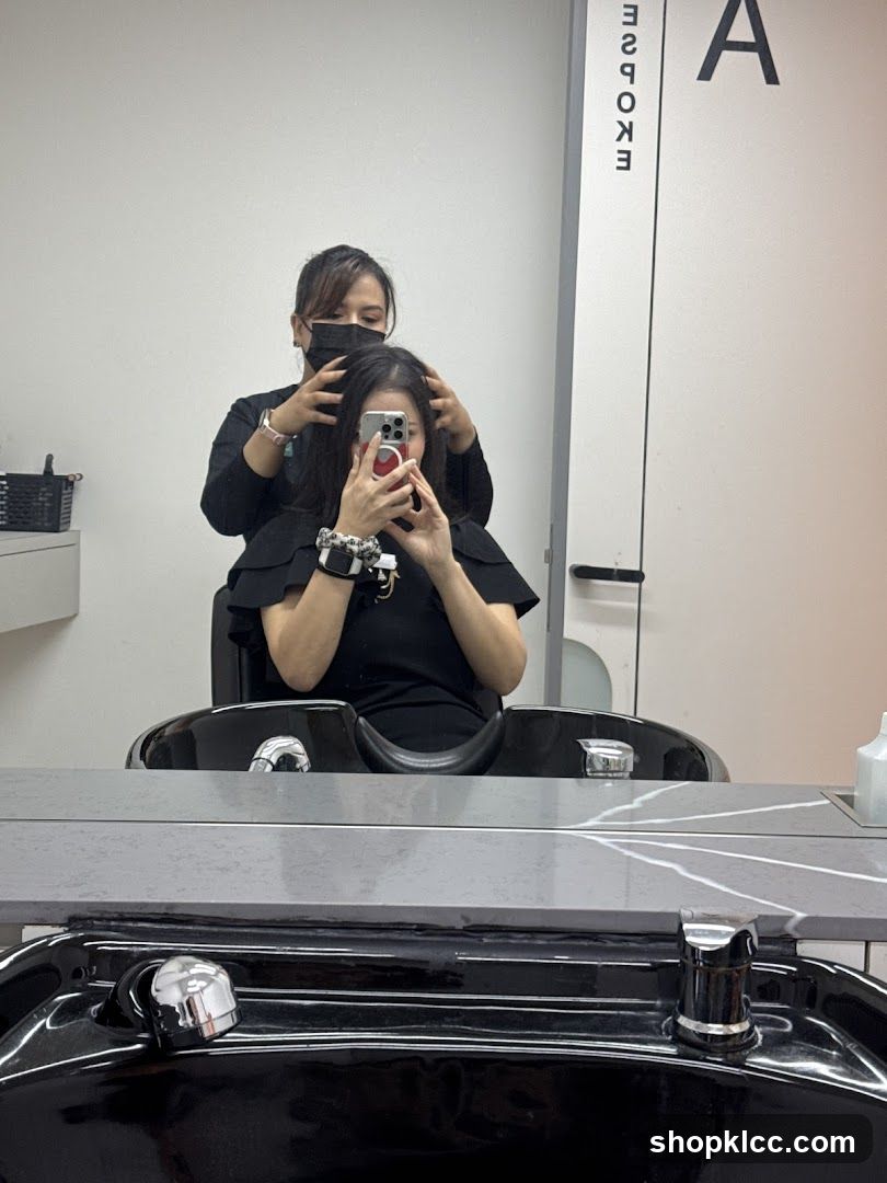 Hairdresser styling client's hair