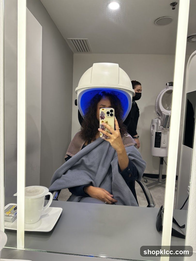 Woman under a hair steamer
