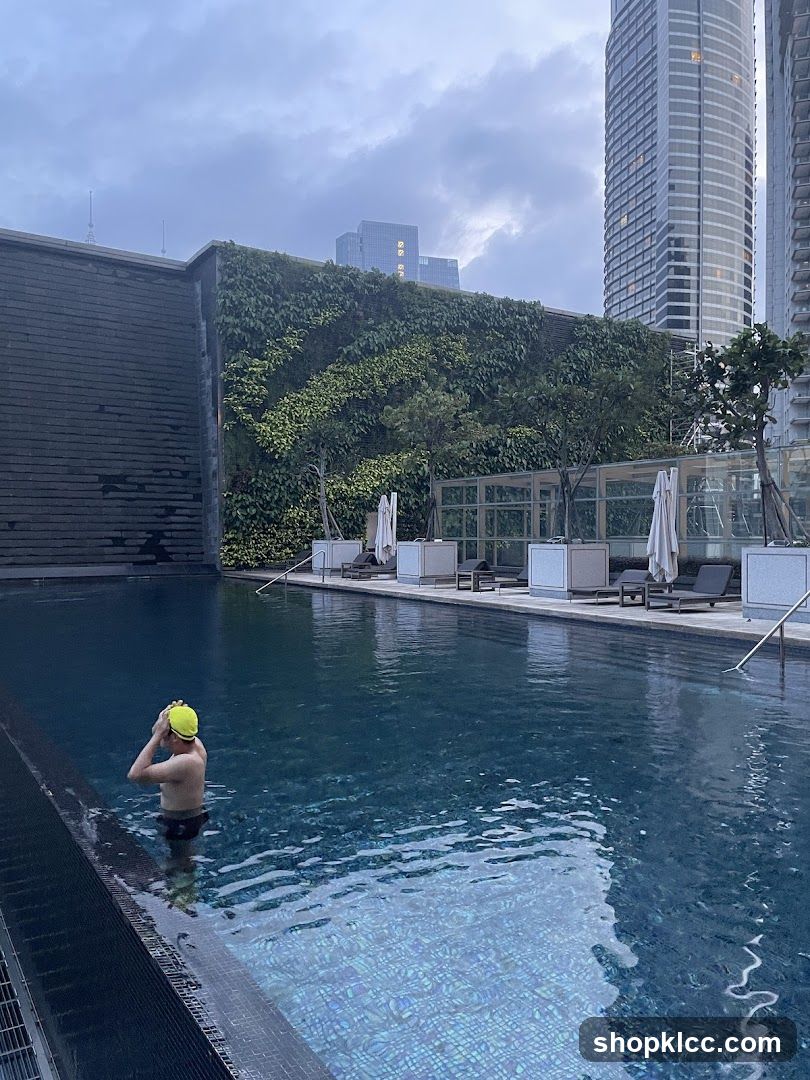 Man in Swimming Pool with Cityscape Background