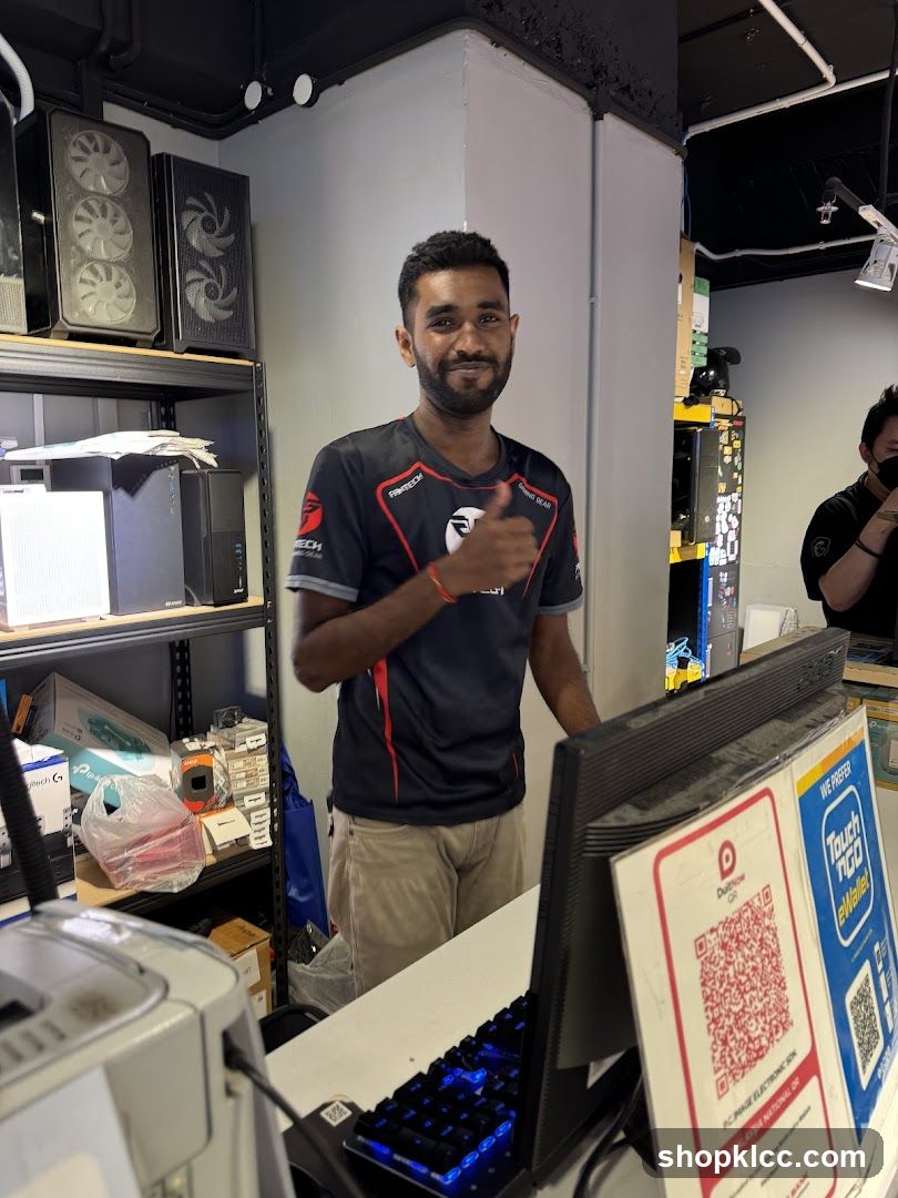 Man giving a thumbs up at a computer desk