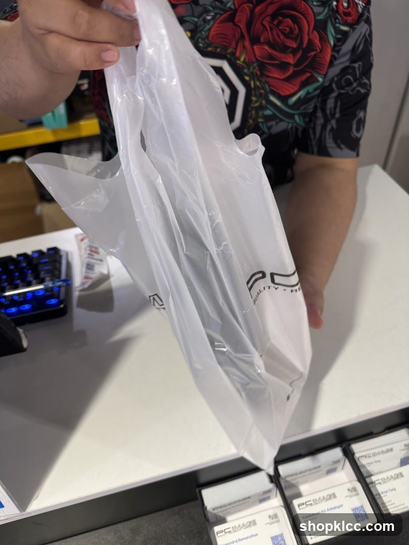 Person holding a plastic bag with a logo