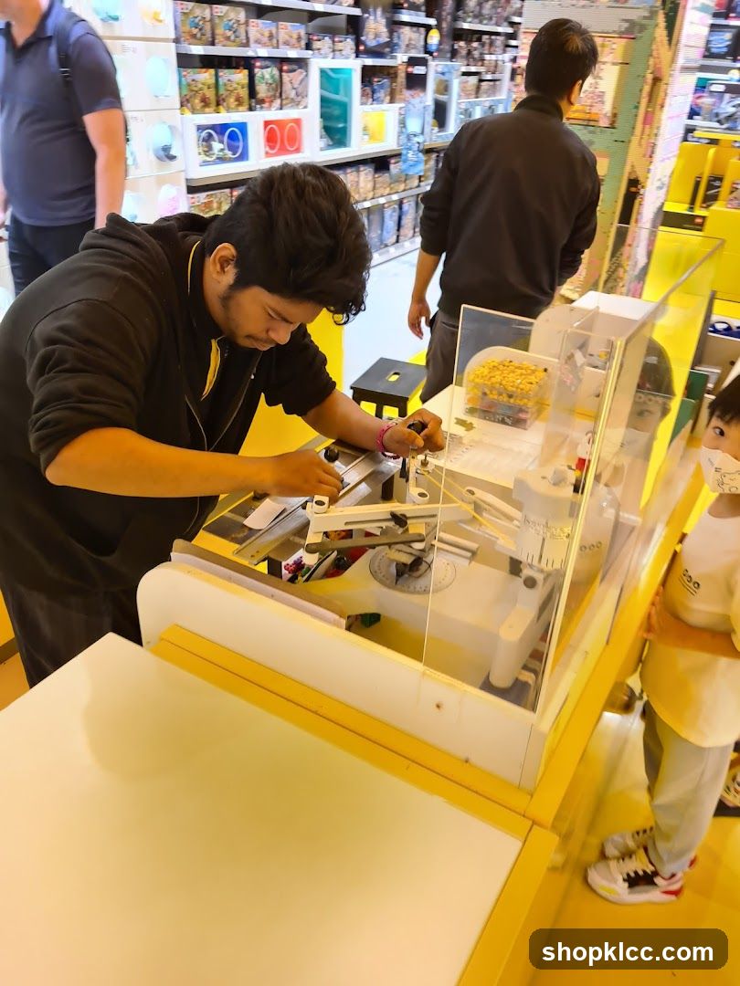 Man operating a Lego building machine