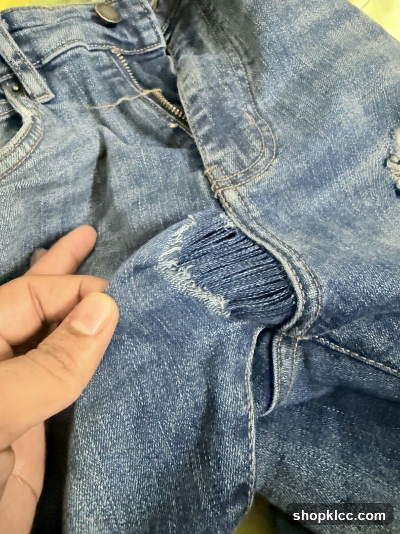 Close-up of ripped denim jeans