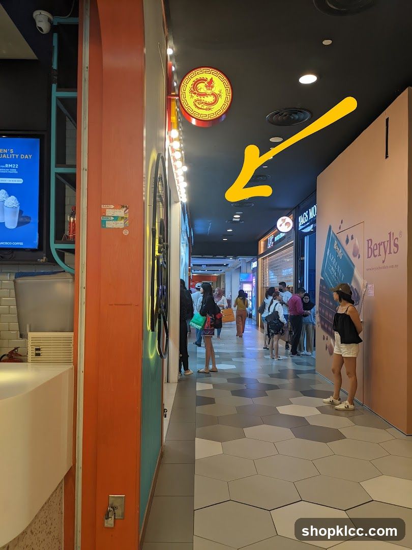 Shopping mall corridor with shops and people