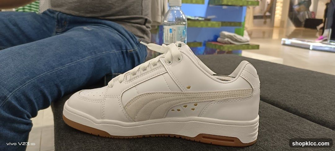 White Puma Sneaker on Gray Surface