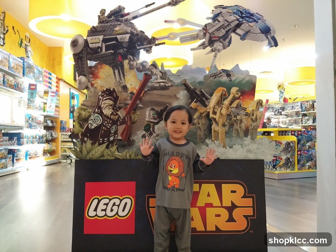 Child Poses in Front of Lego Star Wars Display