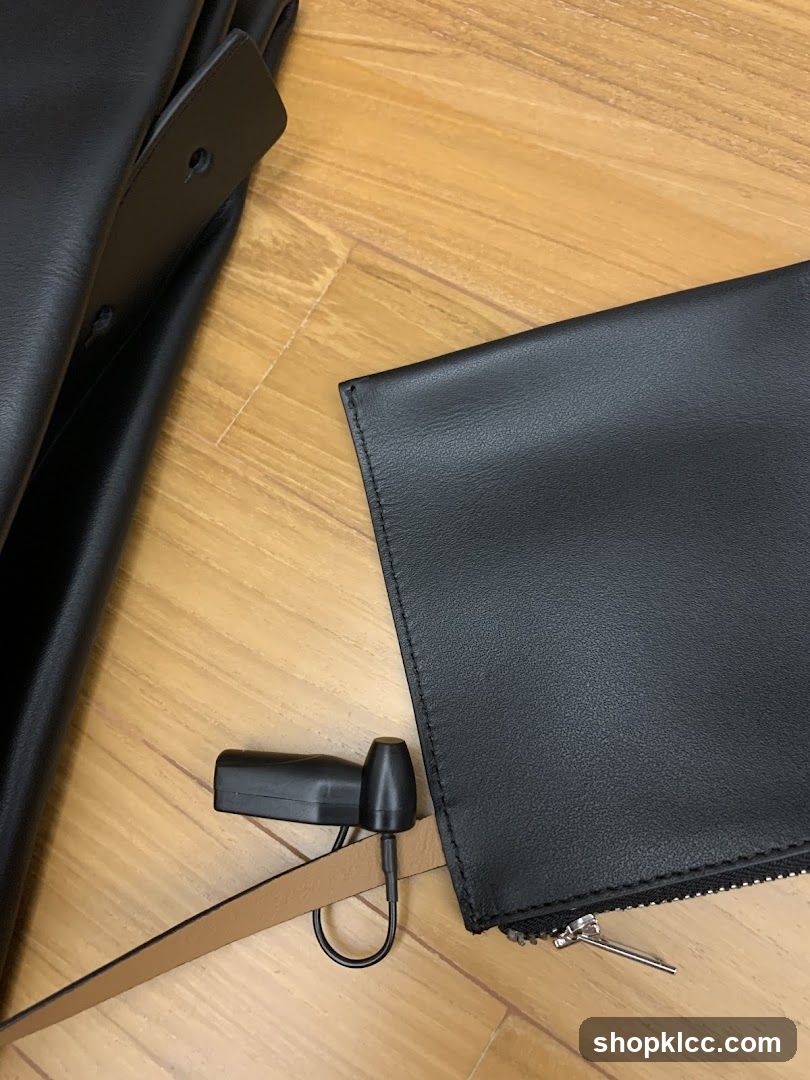 Black Leather Wallet and Strap on Wooden Floor