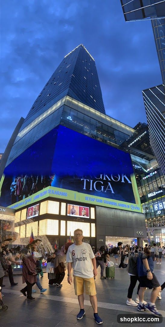 Urban Night Scene with Crowds and Bright Building