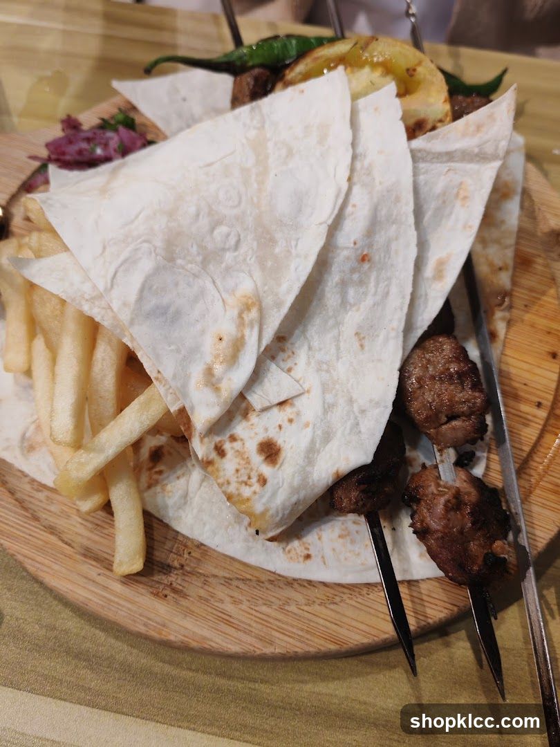 Meat skewers with flatbread and fries