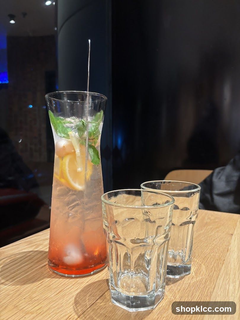 Pitcher of pink drink with lemon and mint