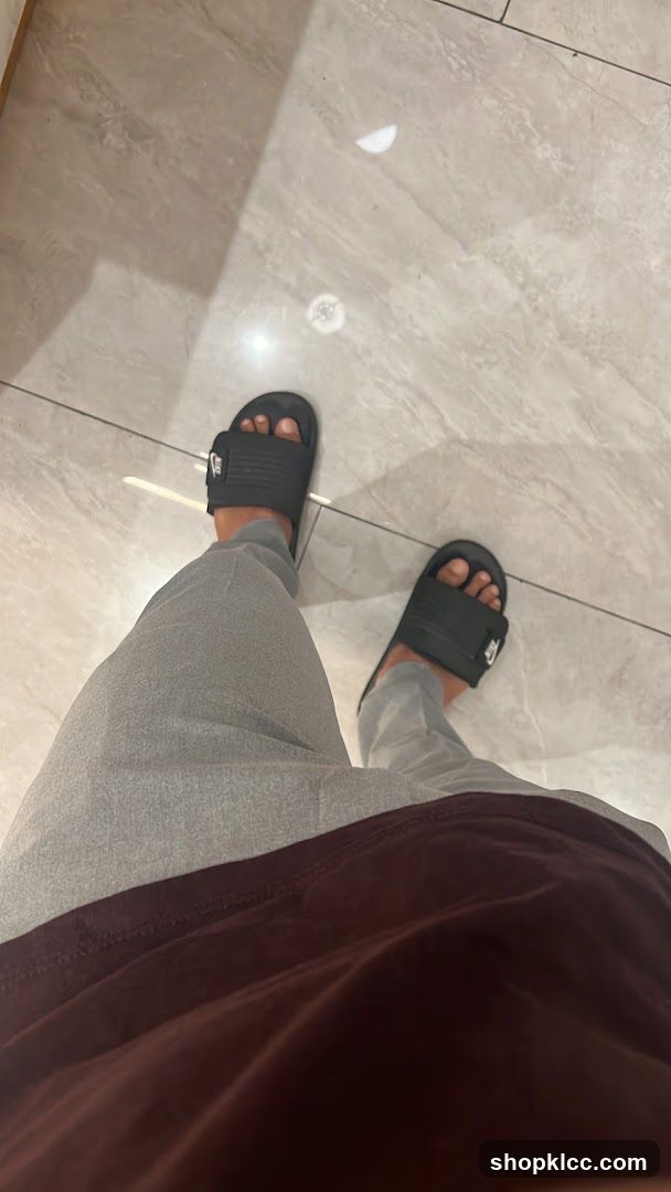 Person wearing Nike slides