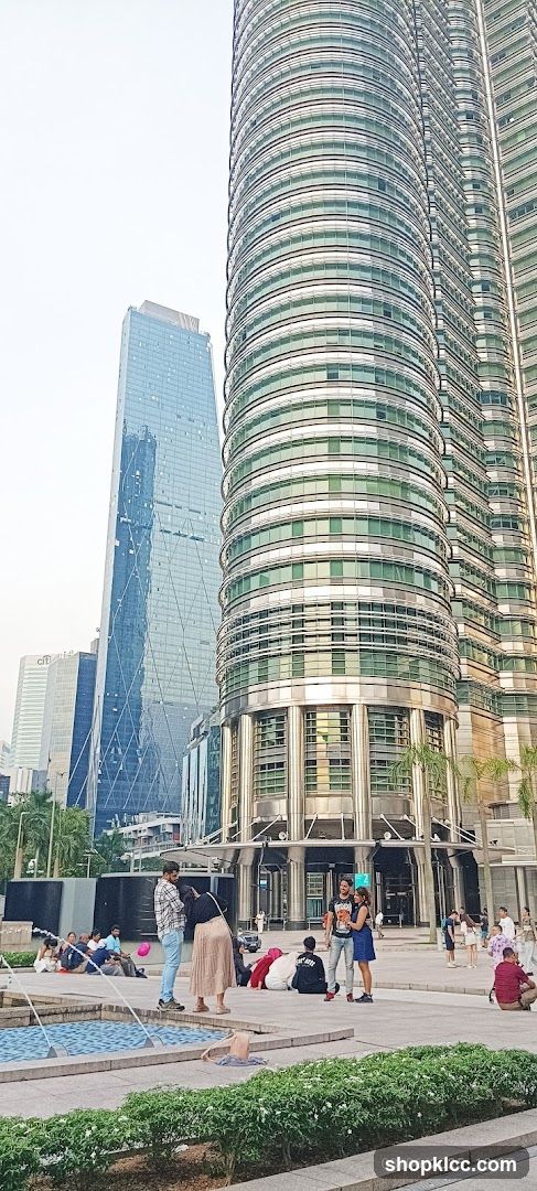 People relaxing near modern skyscrapers
