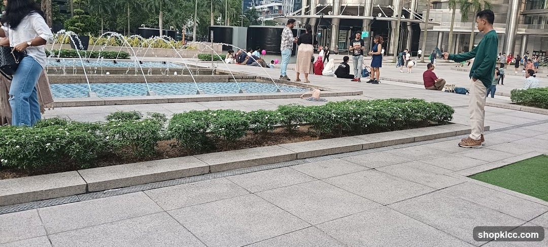 People relaxing by fountains