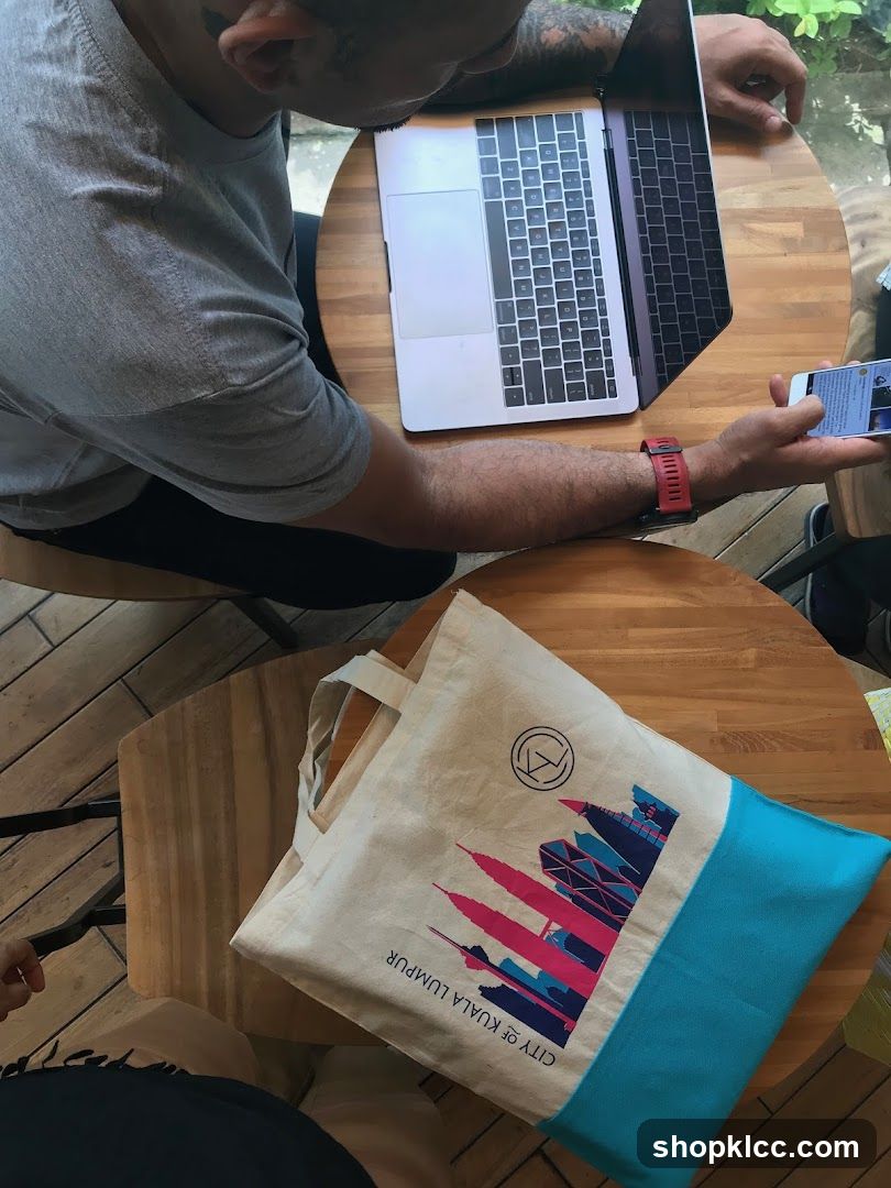 Person with laptop and tote bag
