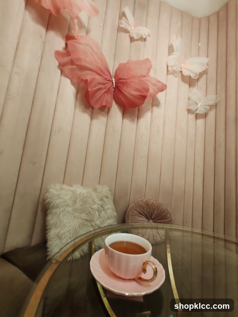 Tea cup on a table with decorative butterflies on the wall