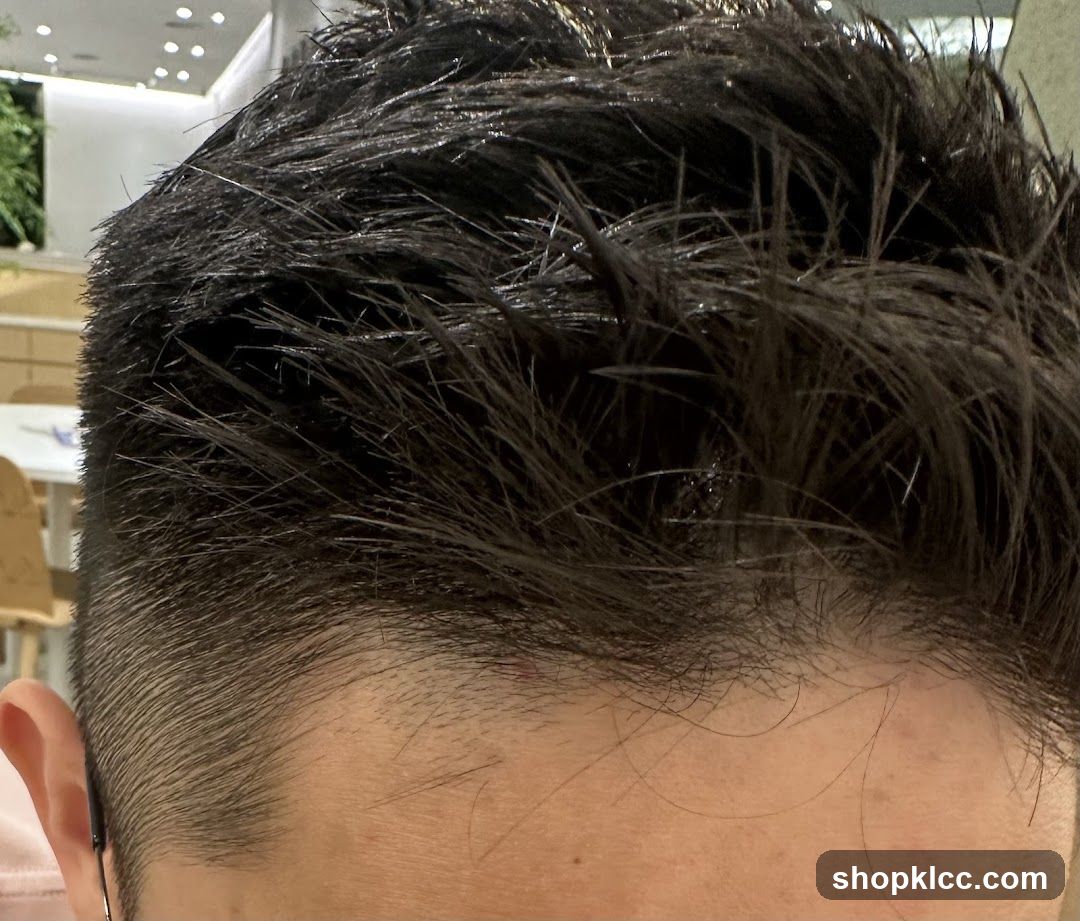Close-up of a man's dark, styled hair