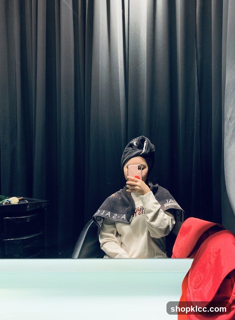 Woman taking a selfie in a salon
