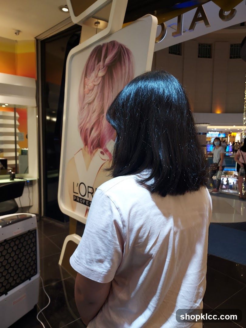Woman looking at L'Oréal hair advertisement