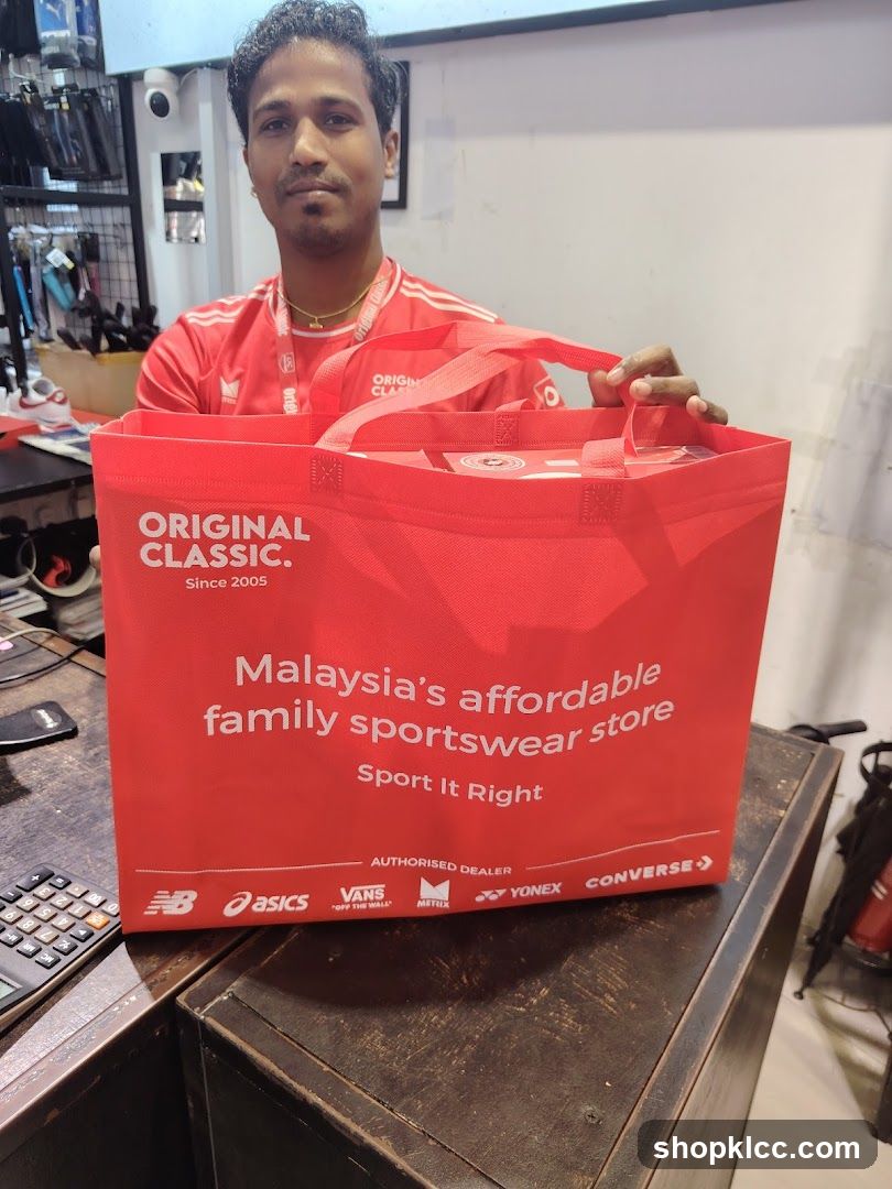 Man holding a red shopping bag