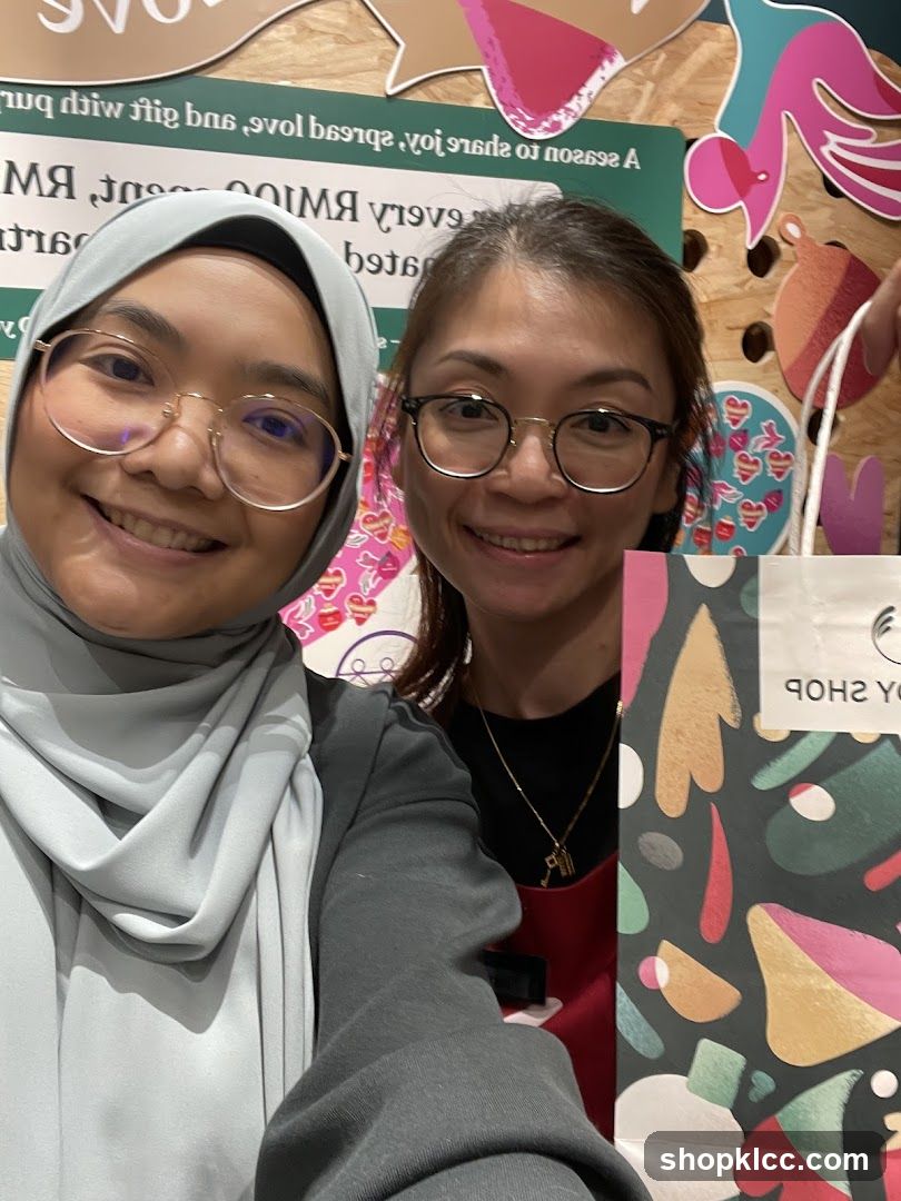 Two Women Posing with a Shopping Bag