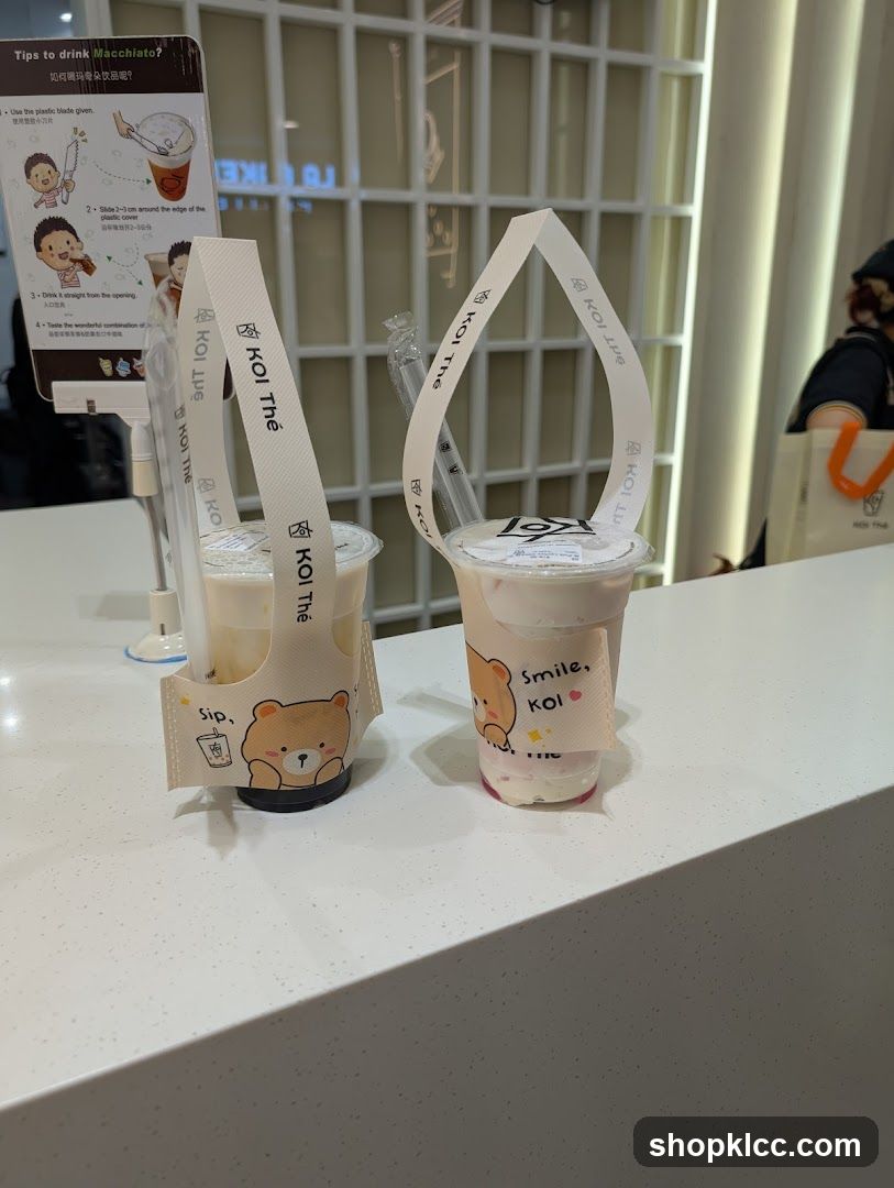 Two drinks with branded sleeves
