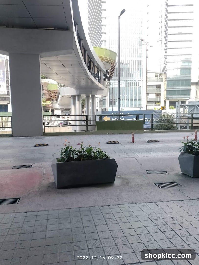 Urban walkway with planters and buildings