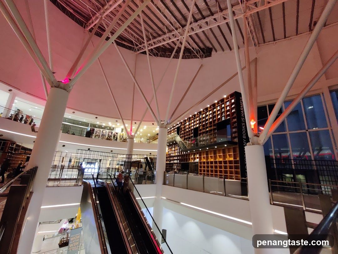 Interior of a multi-level building with escalators and bookshelves