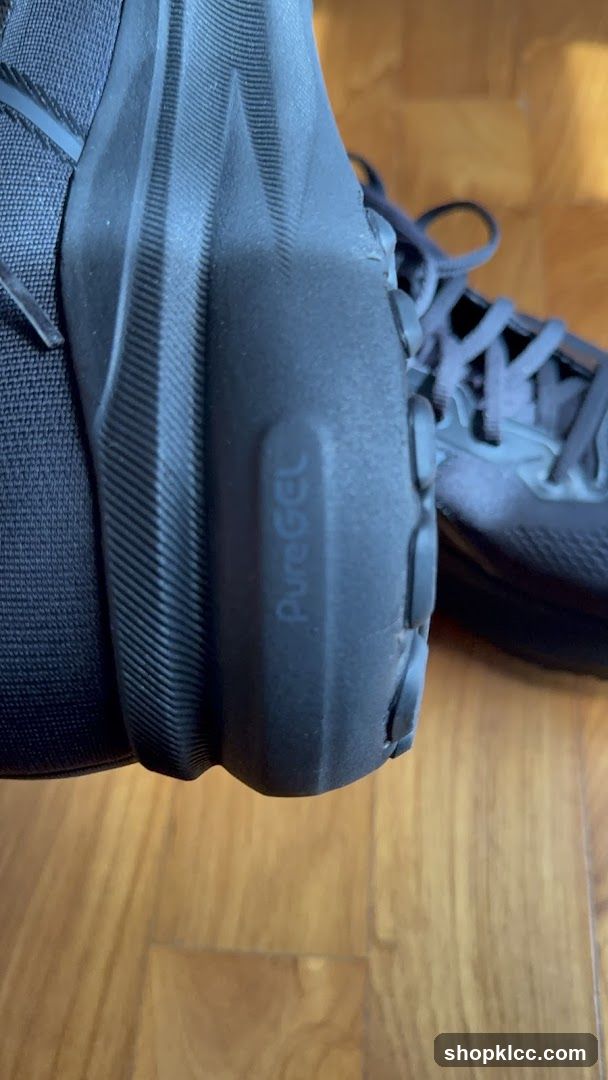 Black athletic shoe with "PureGEL" branding