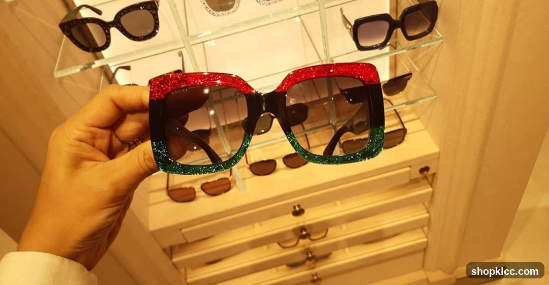 Hand holding Gucci sunglasses