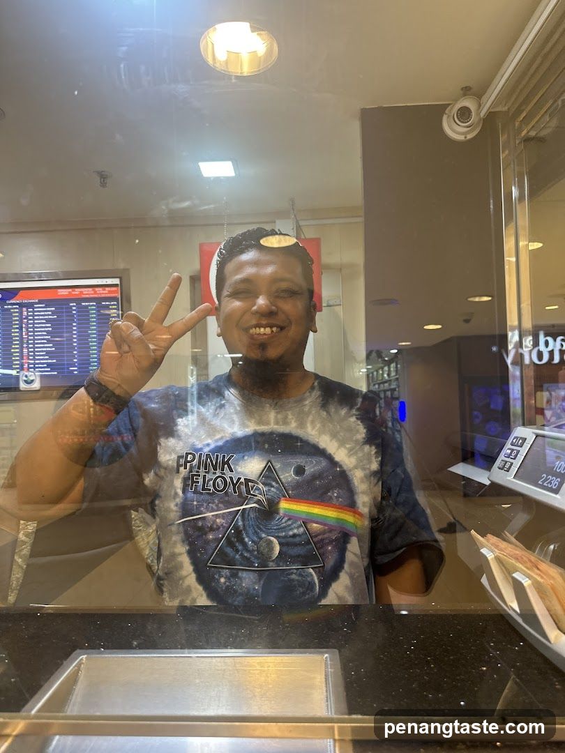 Man in Pink Floyd T-shirt at Counter