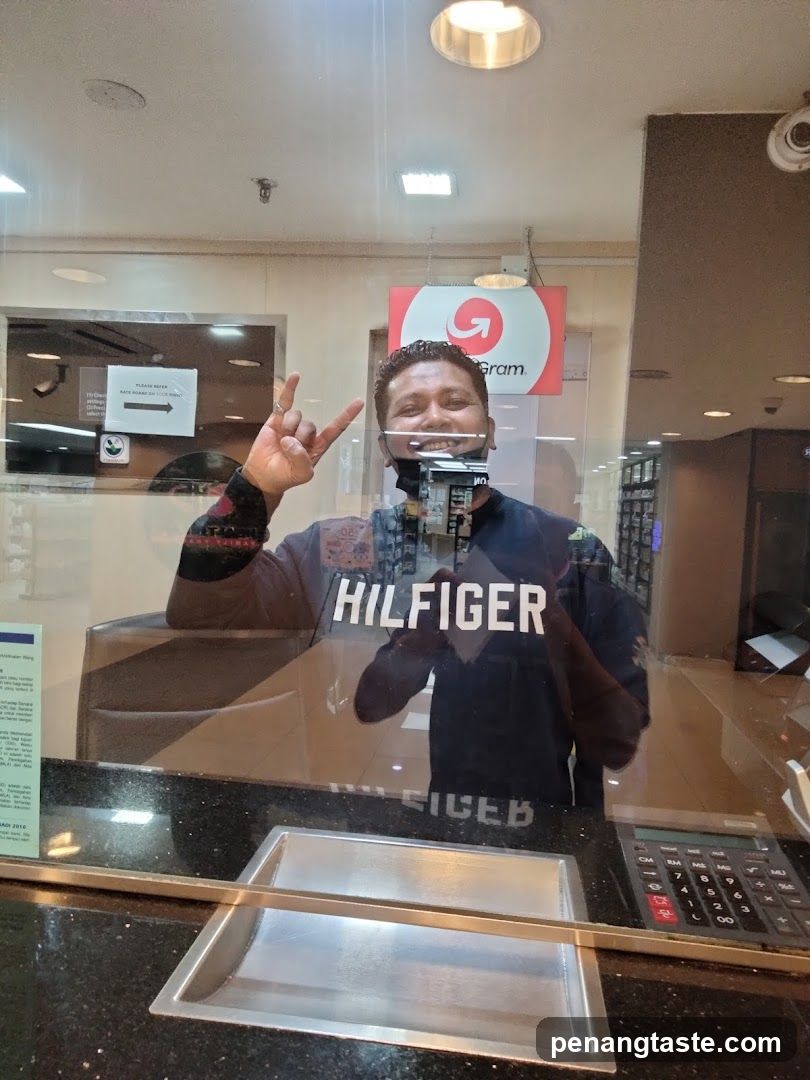 Man posing for a photo at a counter