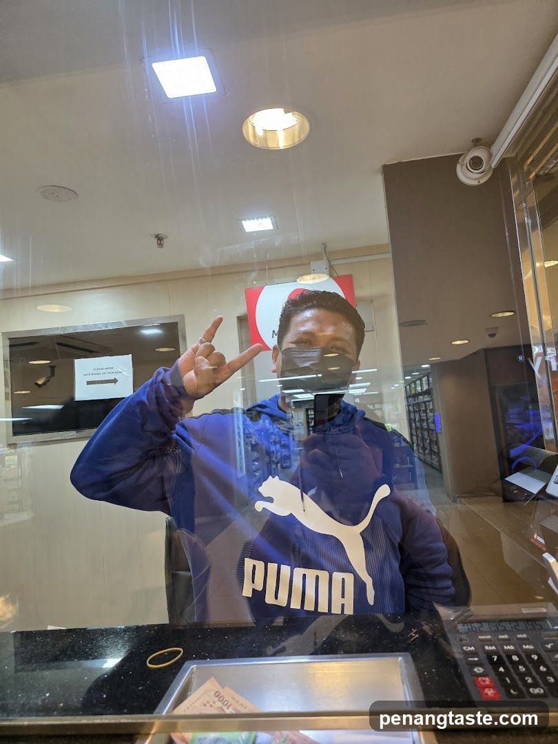 Man in Puma Hoodie at Counter