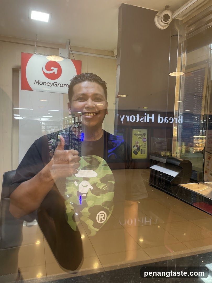 Man giving a thumbs up in front of a MoneyGram sign