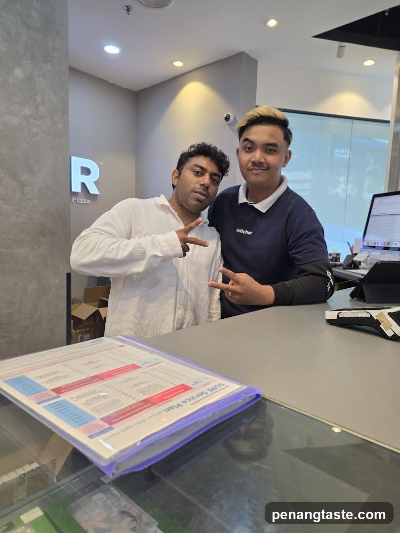Two men posing at a counter
