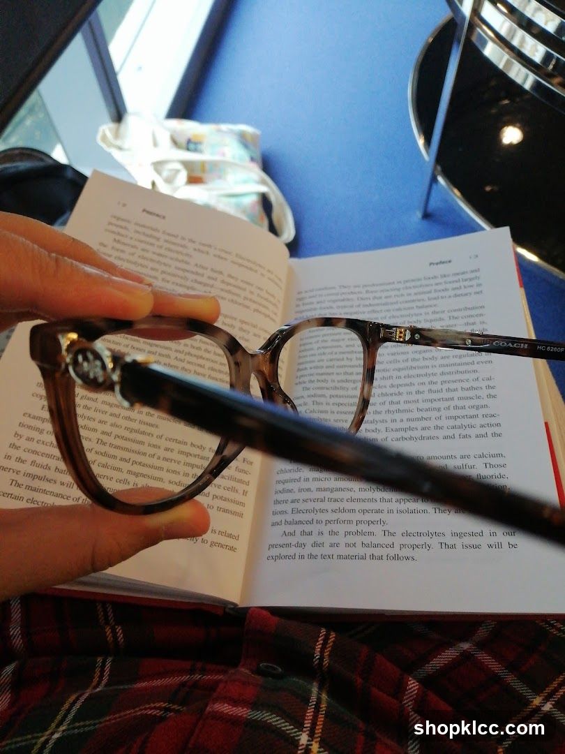 Person reading a book with glasses