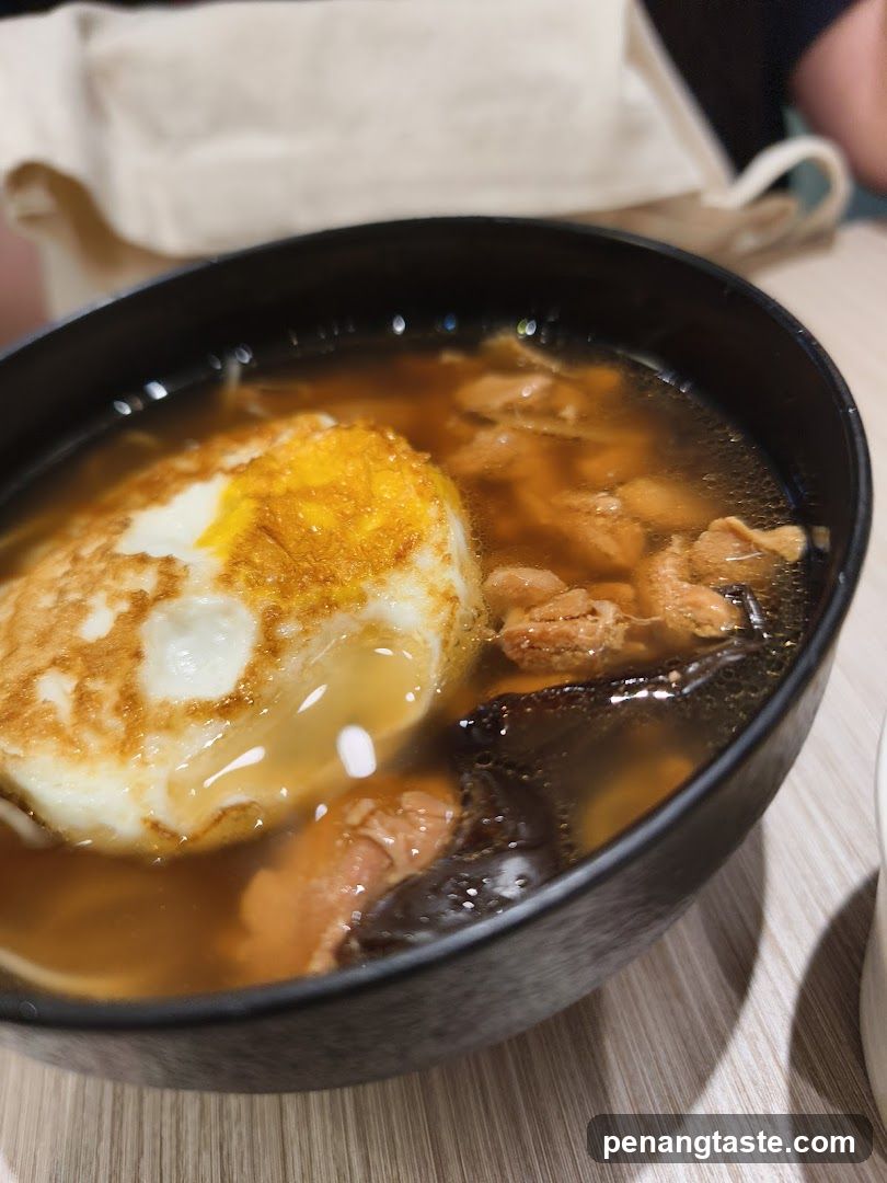 Bowl of Soup with Egg and Meat