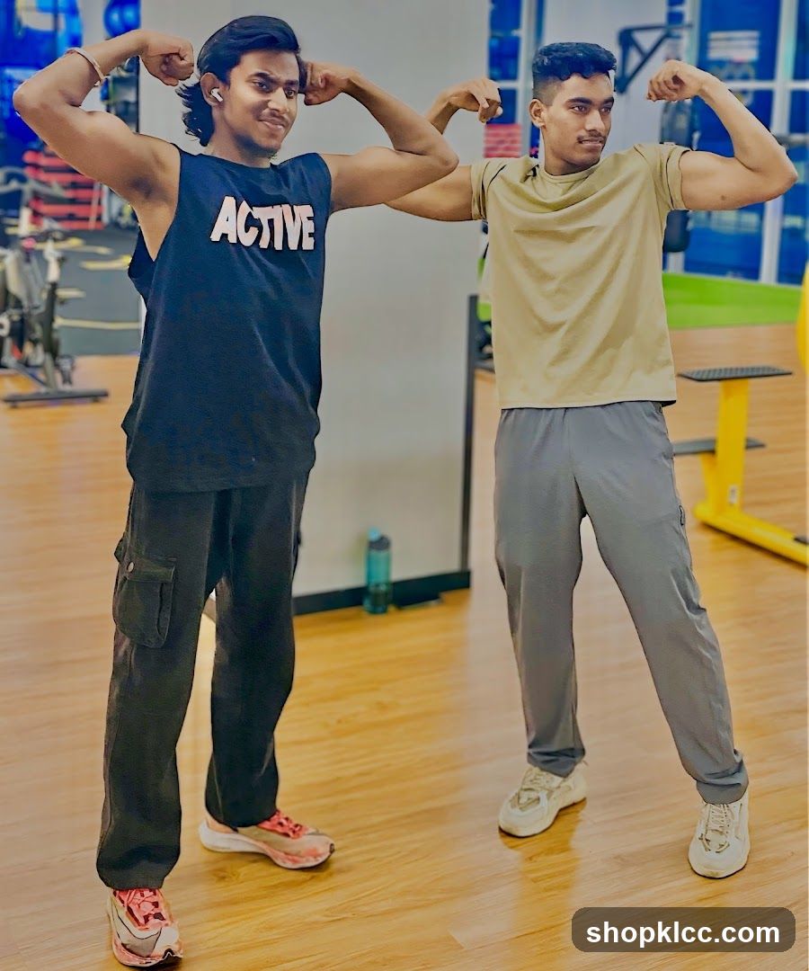 Two men flexing muscles in a gym