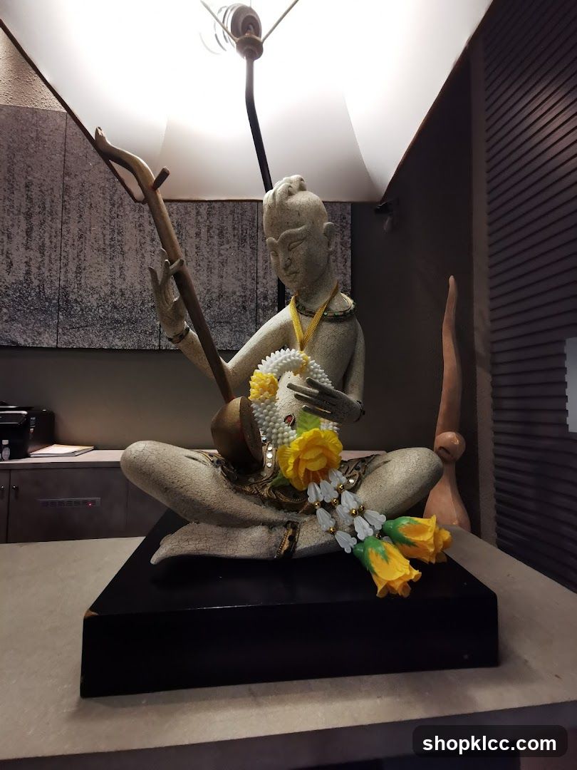Statue with Musical Instrument and Garland