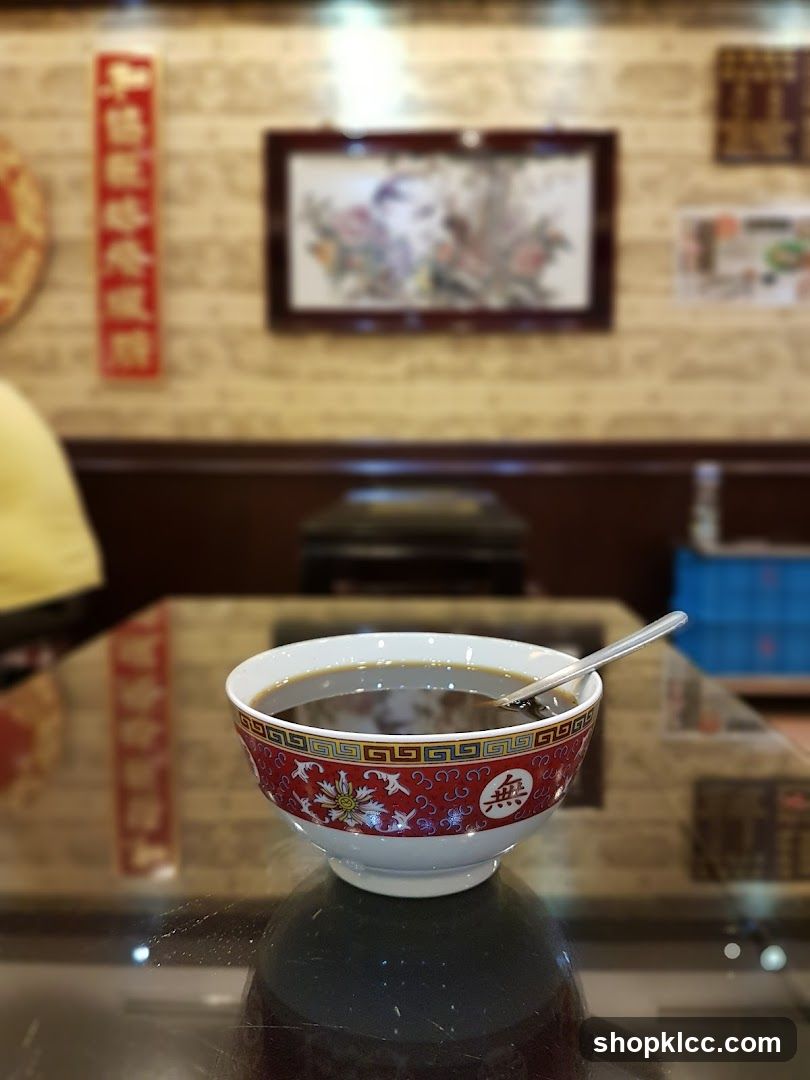 Bowl of dark liquid on a table