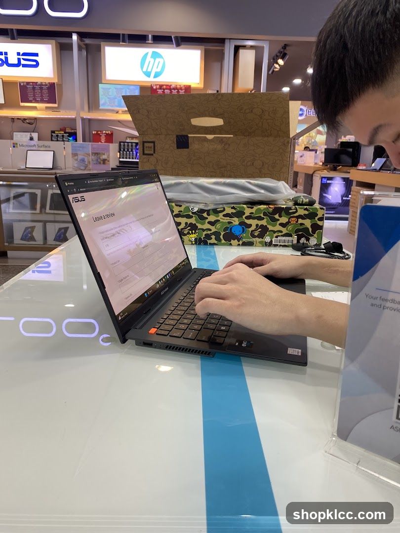 Customer using a laptop in an electronics store