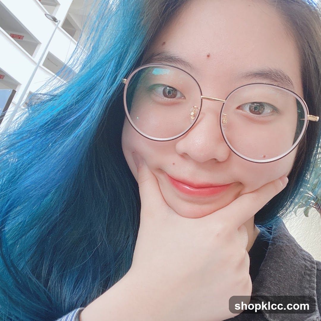 Woman with blue hair and glasses