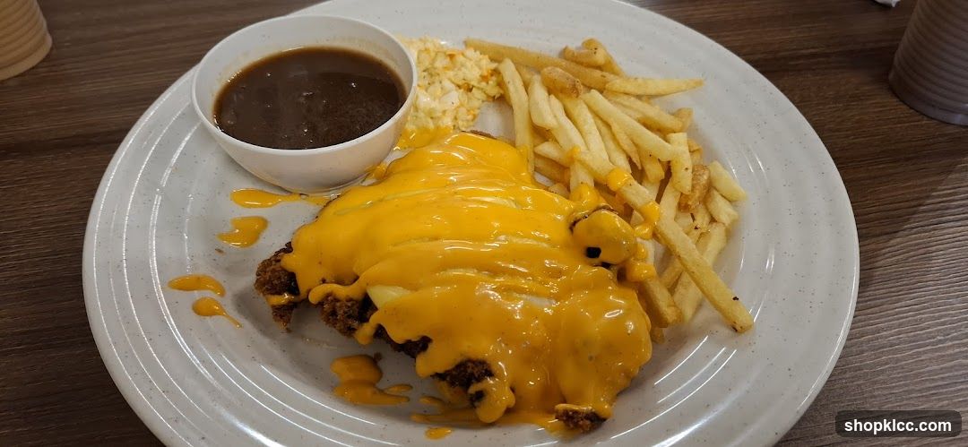 Cheese-covered chicken dish with fries and coleslaw