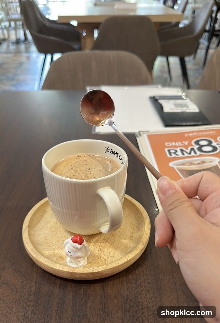 Coffee with a spoon and a small figurine