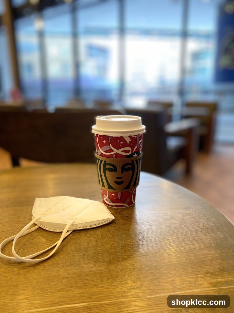 Starbucks Coffee Cup and Mask on Table