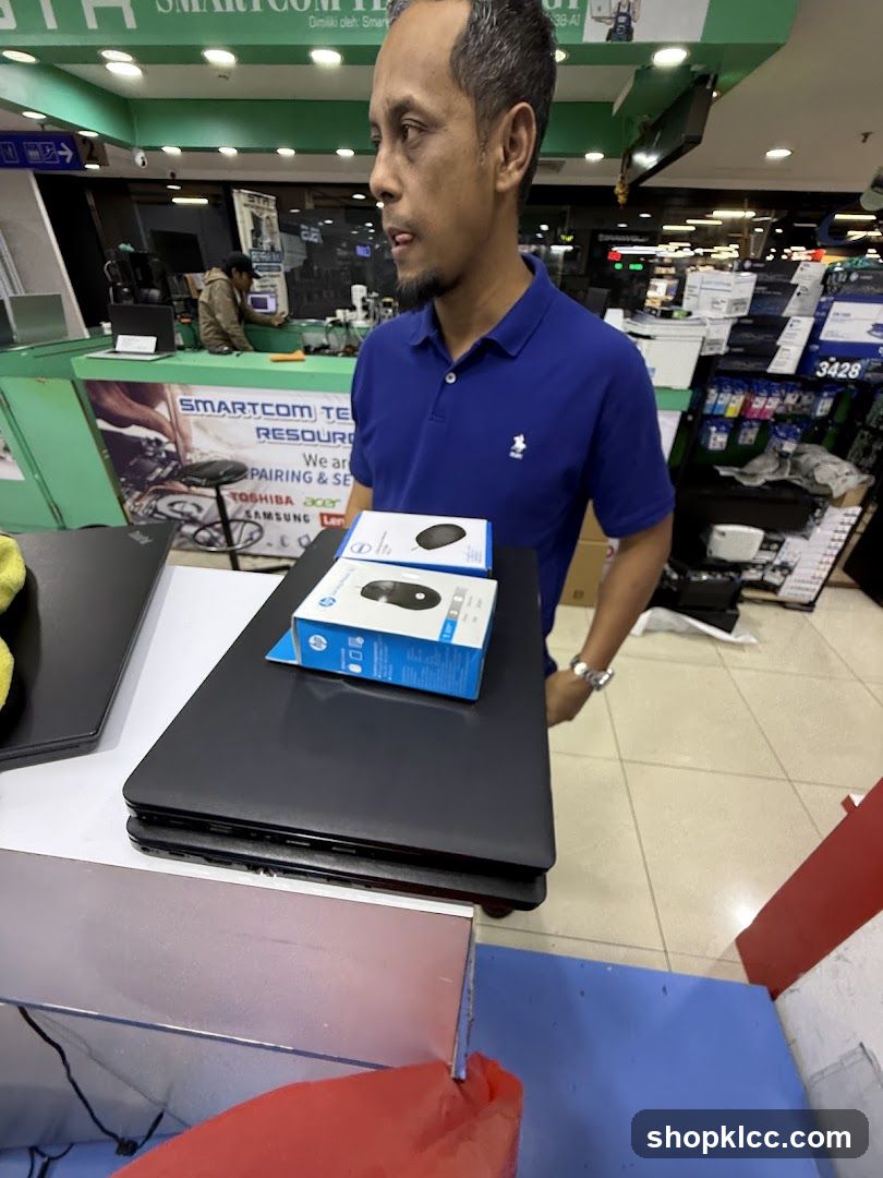 Man holding laptops and computer mice