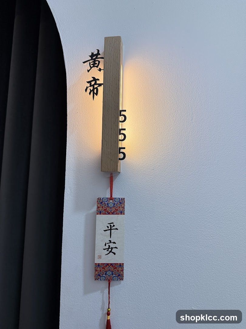 Wall-mounted wooden sign with Chinese characters and hanging charm