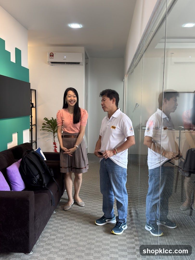 Two people standing in an office hallway