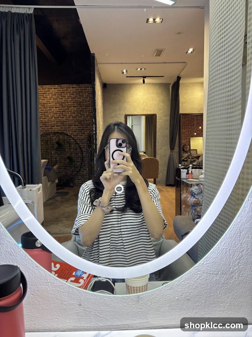 Woman taking a mirror selfie in a salon