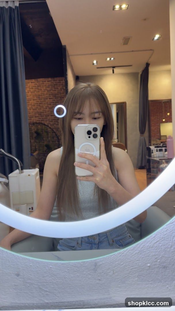 Woman taking a mirror selfie in a salon