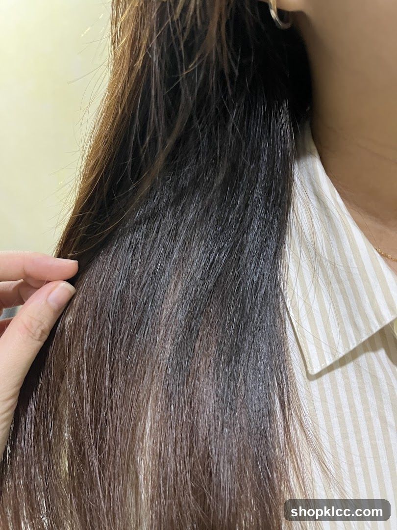 Close-up of person's hair and shoulder